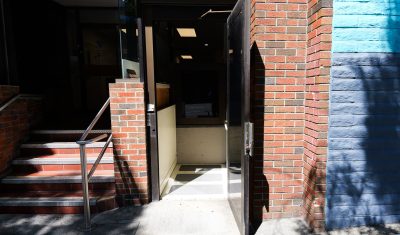 Entrance Building Brick Facade Open Door Stairs Entrance to a building with brick facade, open door, and stairs.