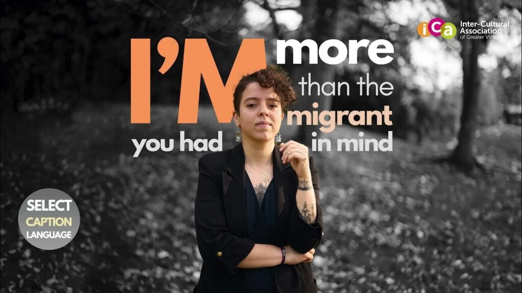 A person with curly hair and tattoos is shown in front of text that reads "I'm more than the migrant you had in mind.