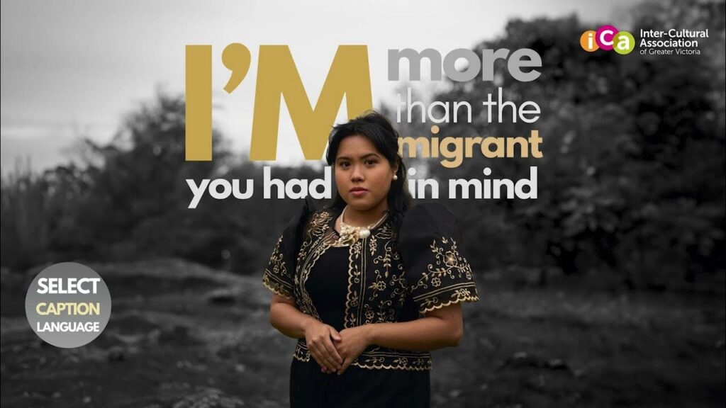 A woman in traditional clothing poses in front of text reading "I'm more than the migrant you had in mind".