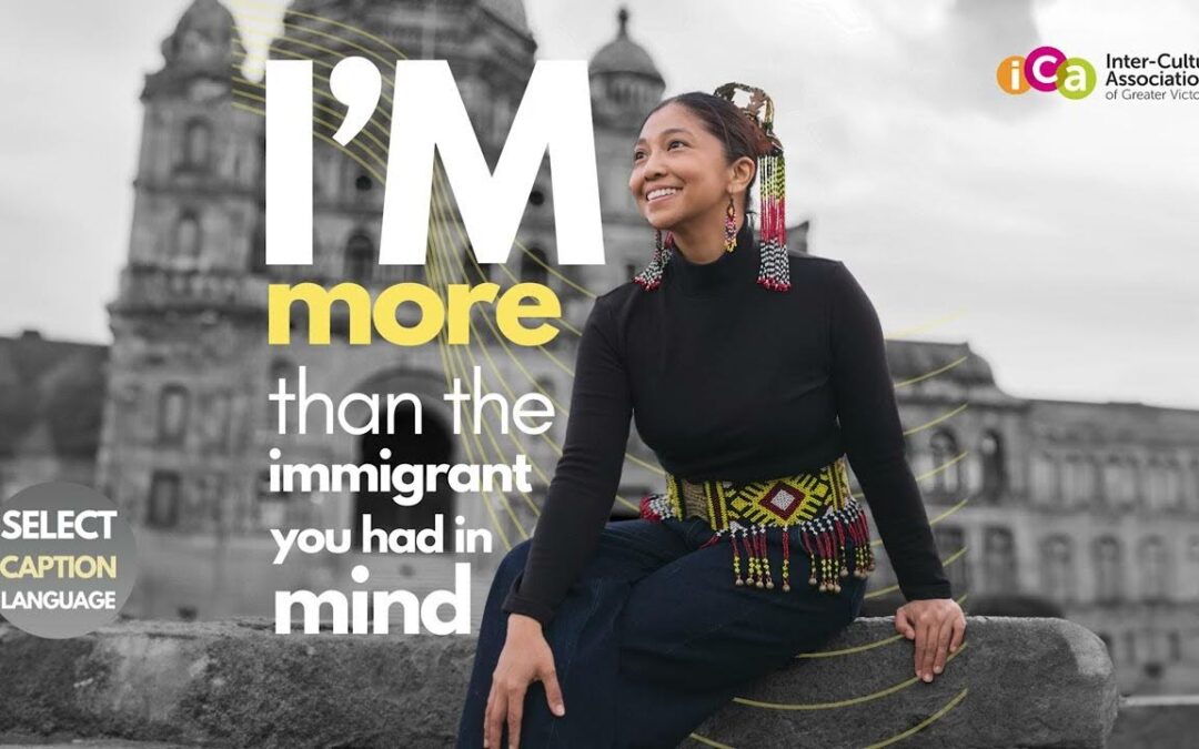 A woman with decorative earrings and belt sits in front of a blurred building and text that reads "I'm more than the immigrant you had in mind".