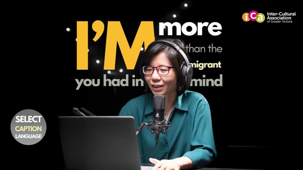 A woman wearing headphones and glasses speaks into a microphone, in front of a laptop, with text overlaid on a black background.